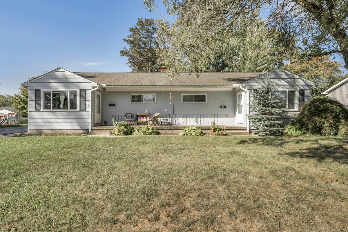 A single-story duplex house with a front porch
