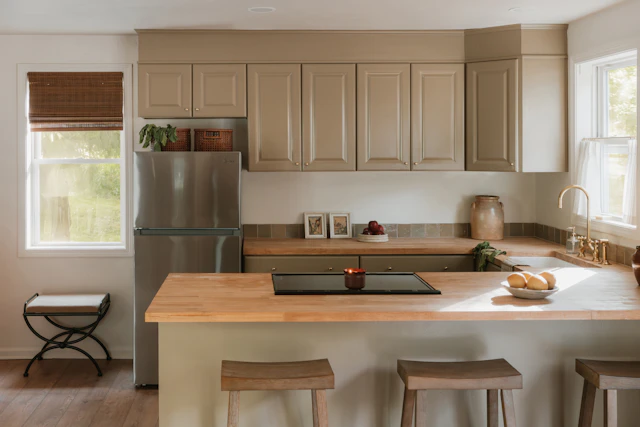 A modern kitchen with light wood countertops and an island